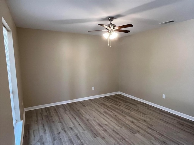 empty room with ceiling fan and hardwood / wood-style flooring