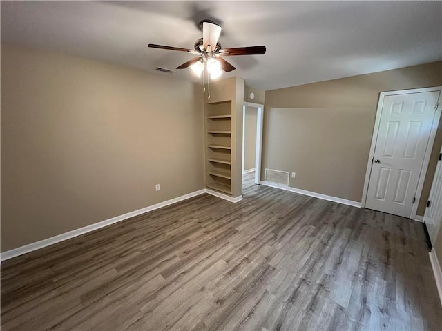 unfurnished room with ceiling fan and hardwood / wood-style flooring