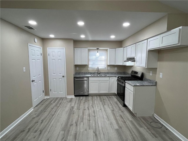 kitchen with white cabinets, sink, stainless steel appliances, and light hardwood / wood-style floors