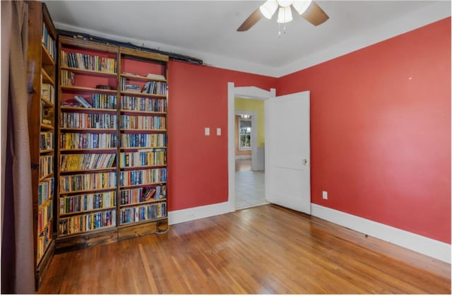 empty room with hardwood / wood-style flooring and ceiling fan