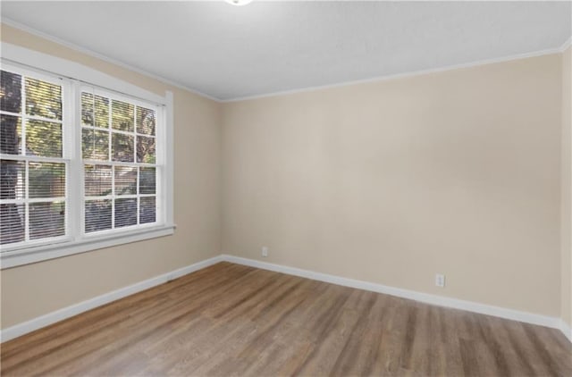 unfurnished room featuring hardwood / wood-style floors and crown molding