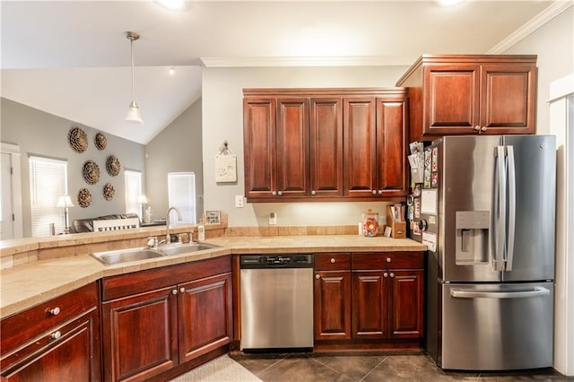 kitchen featuring pendant lighting, dark tile patterned flooring, sink, lofted ceiling, and appliances with stainless steel finishes