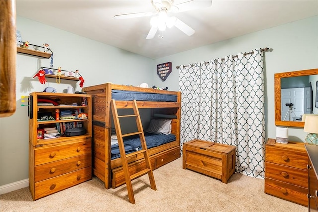 bedroom featuring light carpet and ceiling fan