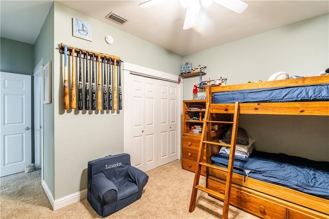 bedroom with light carpet, a closet, and ceiling fan