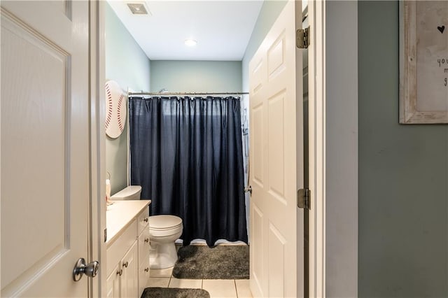 bathroom with tile patterned flooring, curtained shower, vanity, and toilet