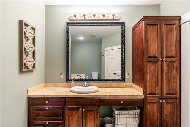 bathroom with vanity and toilet