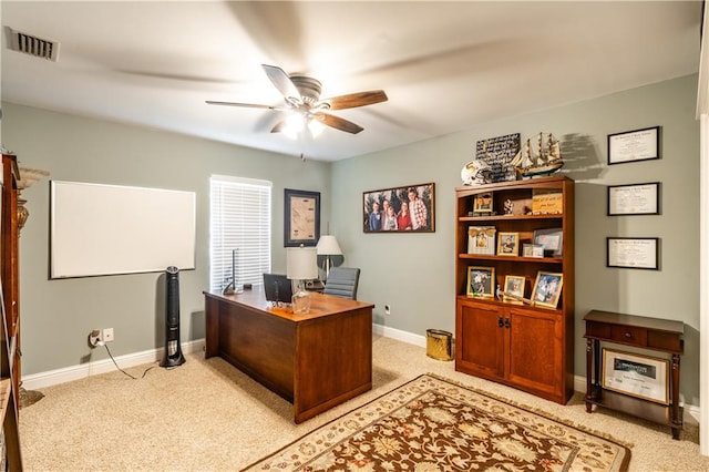 carpeted office featuring ceiling fan