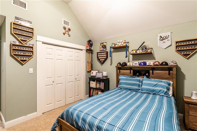 carpeted bedroom featuring a closet and vaulted ceiling