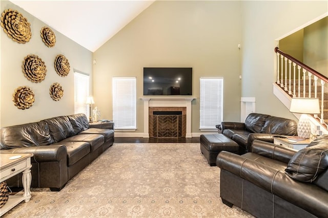 living room with high vaulted ceiling