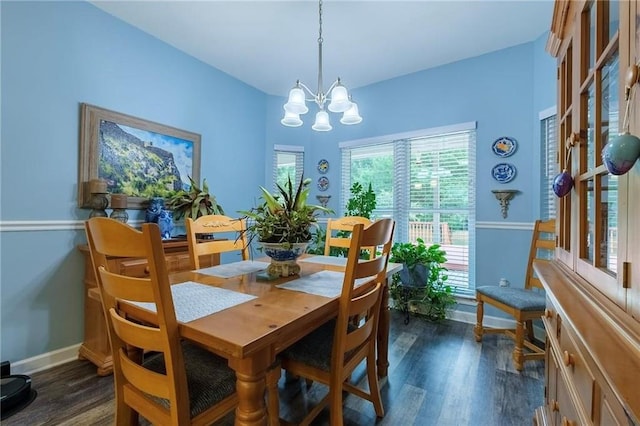 dining space with a notable chandelier and dark hardwood / wood-style floors