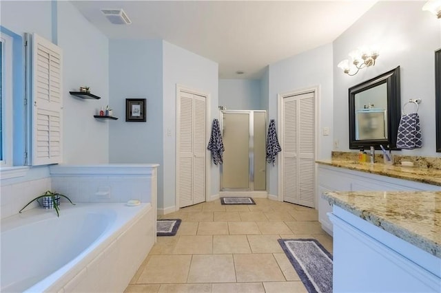 bathroom featuring vanity, plus walk in shower, and tile patterned flooring