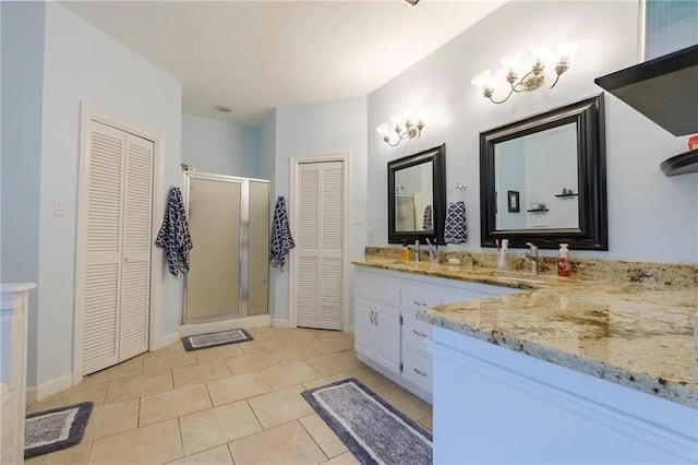 bathroom with vanity, tile patterned flooring, and a shower with door