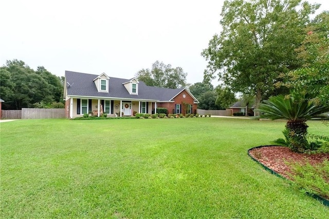 cape cod-style house with a front yard