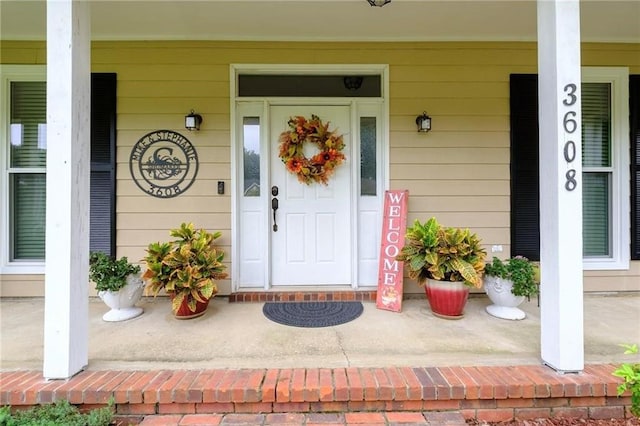 view of exterior entry with a porch