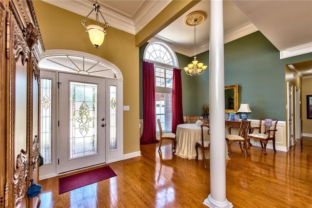 entryway featuring decorative columns, a healthy amount of sunlight, and ornamental molding