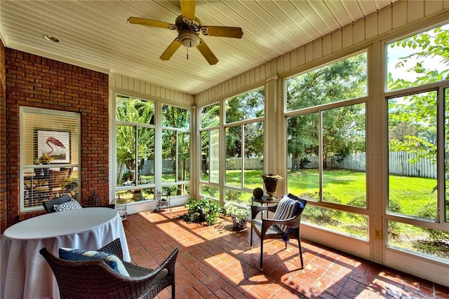 sunroom / solarium featuring ceiling fan