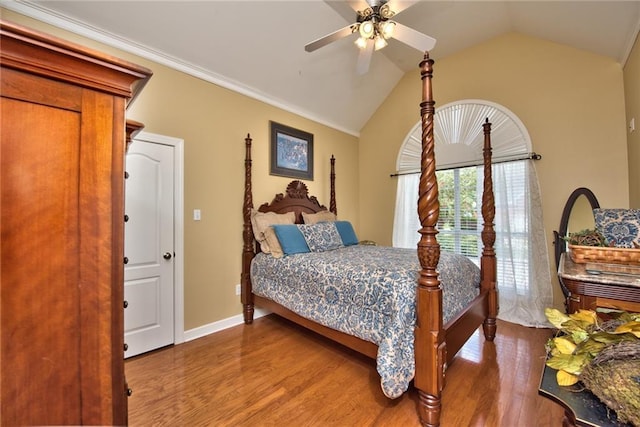 bedroom featuring ceiling fan, ornamental molding, lofted ceiling, and hardwood / wood-style flooring