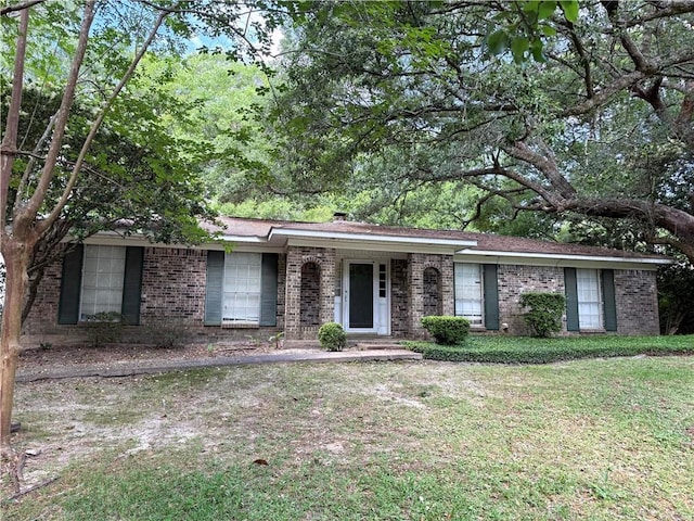 ranch-style house with brick siding and a front lawn