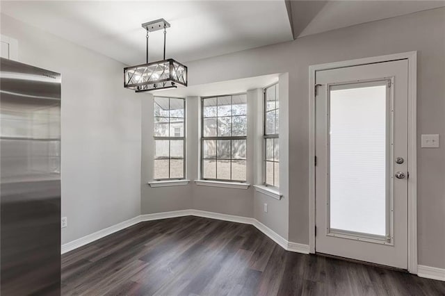 unfurnished dining area with dark hardwood / wood-style floors