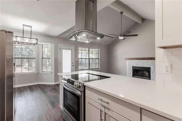 kitchen featuring dark hardwood / wood-style floors, island range hood, decorative light fixtures, white cabinetry, and stainless steel appliances