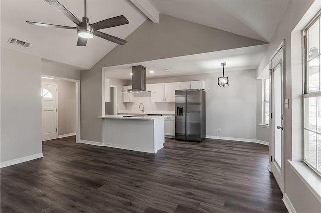 kitchen featuring dark wood-type flooring, white cabinetry, stainless steel fridge, pendant lighting, and island exhaust hood