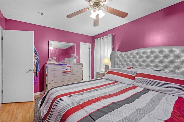 bedroom featuring hardwood / wood-style floors, ceiling fan, and lofted ceiling