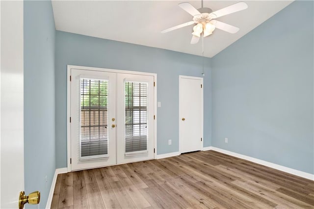 doorway featuring a ceiling fan, french doors, wood finished floors, baseboards, and lofted ceiling