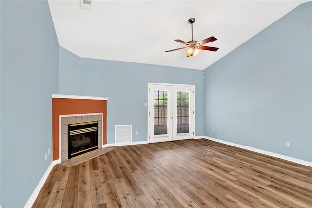 unfurnished living room featuring visible vents, wood finished floors, baseboards, french doors, and a ceiling fan
