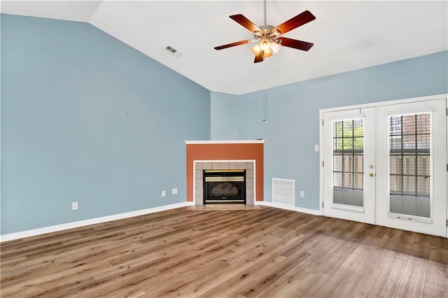 unfurnished living room featuring visible vents, a ceiling fan, wood finished floors, and french doors