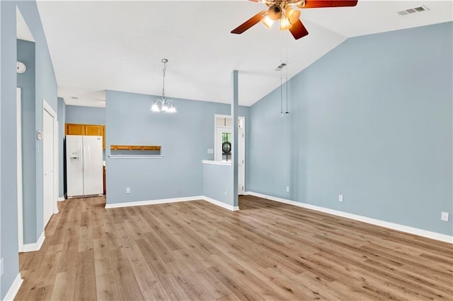 unfurnished living room featuring visible vents, lofted ceiling, baseboards, light wood finished floors, and ceiling fan with notable chandelier