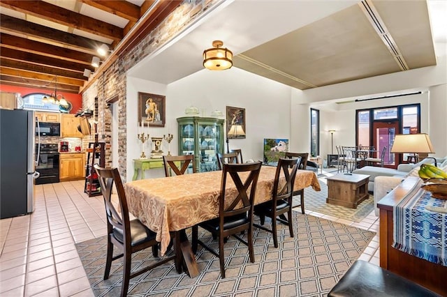 51 Jackson St N Unit A, Mobile, AL 36602 - dining area with light tile patterned floors and lofted ceiling