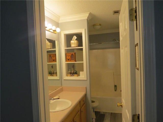 full bathroom with shower / washtub combination, a textured ceiling, toilet, vanity, and crown molding