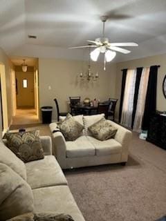 carpeted living room with ceiling fan and lofted ceiling