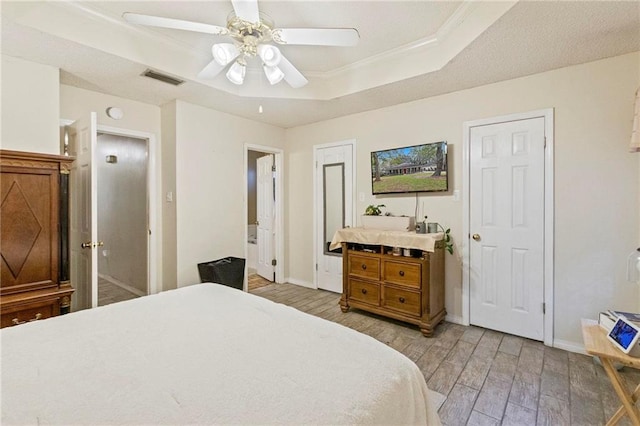 bedroom featuring a tray ceiling and ceiling fan