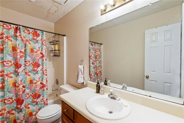 full bathroom featuring shower / tub combo with curtain, vanity, a textured ceiling, and toilet