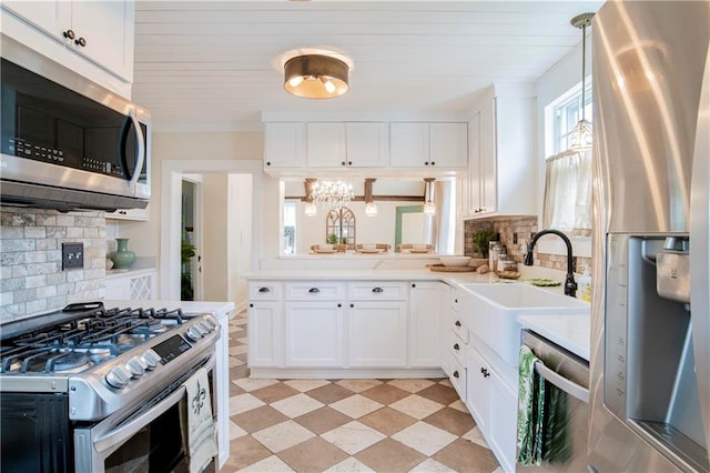 kitchen featuring white cabinets, backsplash, and appliances with stainless steel finishes