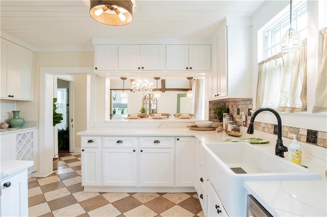 kitchen featuring pendant lighting, light tile patterned floors, decorative backsplash, and white cabinets