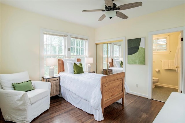 bedroom featuring a closet, ensuite bathroom, ceiling fan, and dark wood-type flooring