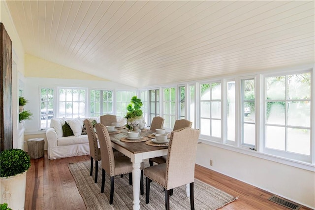 dining space featuring wooden ceiling, lofted ceiling, and hardwood / wood-style floors