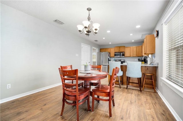 dining space with baseboards, visible vents, light wood-style flooring, and recessed lighting