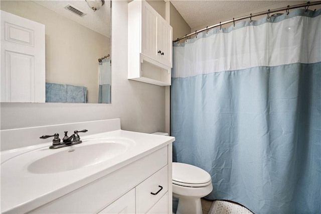 bathroom with visible vents, toilet, curtained shower, a textured ceiling, and vanity