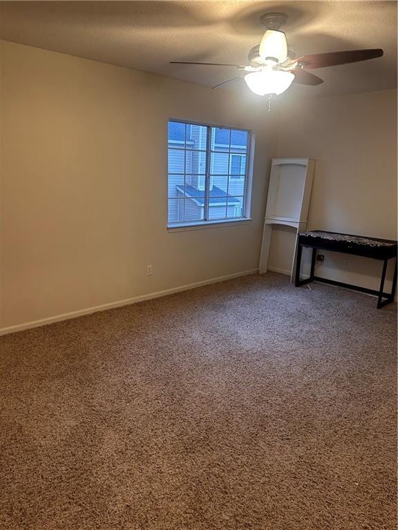 carpeted empty room with ceiling fan