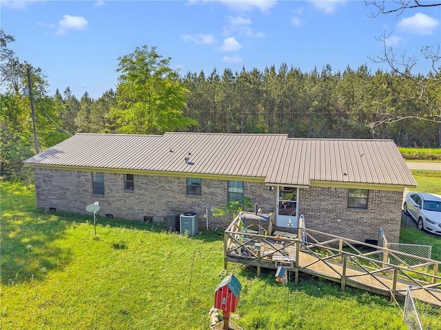 950 Red Fox Rd W, Mount Vernon, AL 36560 - rear view of house with brick siding, central AC, and a lawn
