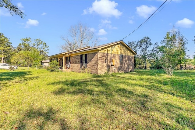 950 Red Fox Rd W, Mount Vernon, AL 36560 - back of house featuring brick siding and a lawn