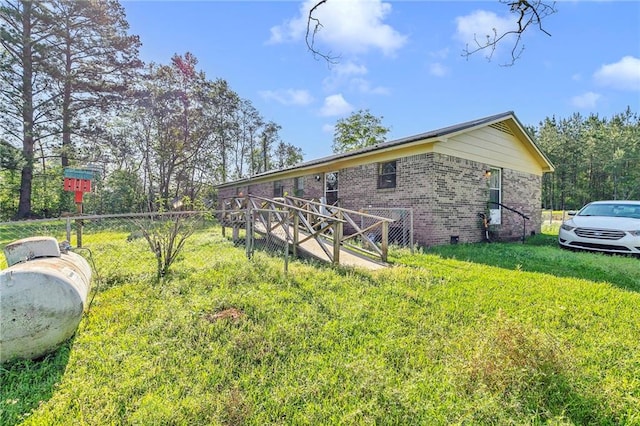 950 Red Fox Rd W, Mount Vernon, AL 36560 - view of side of home featuring brick siding, fence, and a yard
