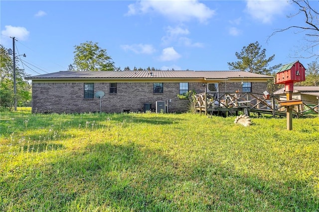 950 Red Fox Rd W, Mount Vernon, AL 36560 - rear view of house featuring brick siding, a deck, and metal roof