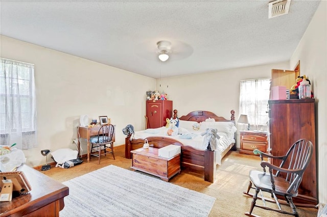 950 Red Fox Rd W, Mount Vernon, AL 36560 - bedroom with a textured ceiling, ceiling fan, and visible vents
