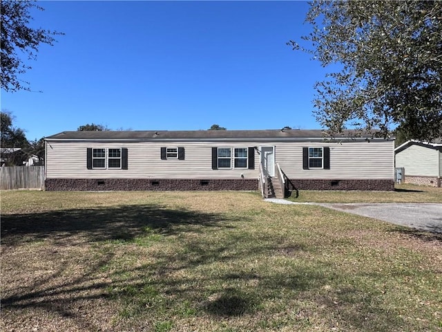 manufactured / mobile home with crawl space, fence, a front lawn, and entry steps