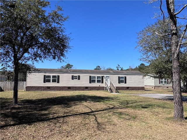 manufactured / mobile home with entry steps, crawl space, a front yard, and fence