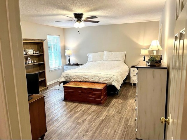8653 Rosalene St E, Grand Bay, AL 36541 - bedroom with wood finished floors, a textured ceiling, baseboards, and ceiling fan